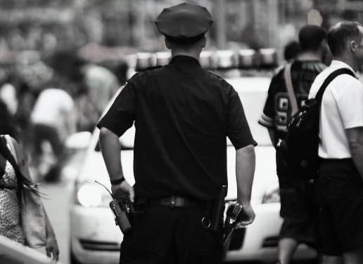 176418000-new-york-city-police-officer-stands-in-times-square-on.jpg.CROP.promo-mediumlarge